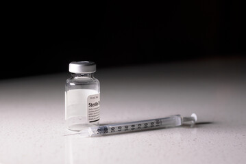 Medication Vial and Syringe for Corona-19 Vaccination in a Clinical, Isolated background.