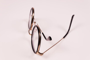 side view of glasses that lie vertically with one arm slightly extended and the other folded