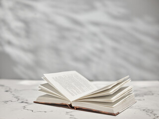 Open book on white table