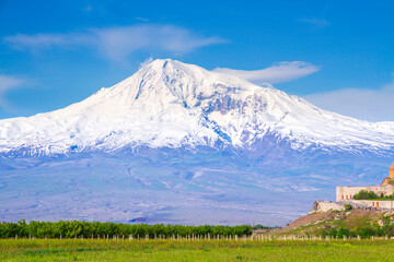 Awe-Inspiring medieval Khor Virap monastery in front of Mount Ararat viewed from Yerevan, Armenia. This snow-capped dormant compound volcano described in the Bible as the resting place of Noah's Ark.