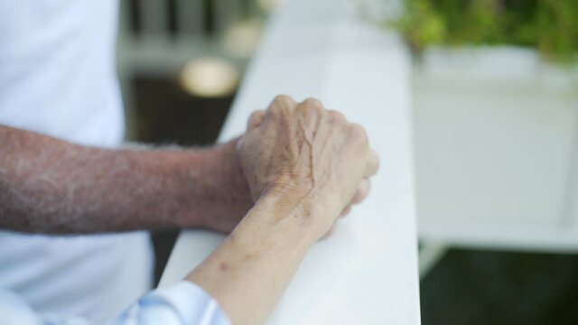 Elderly Man and Woman Holding Hands