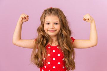 A little girl with curly hair shows her strength.