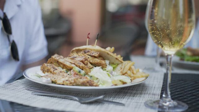 Food Being Served to Caucasian Man at a Restaurant in Long Island