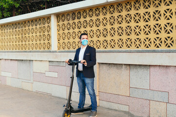 Masked man driving an electric scooter during the pandemic