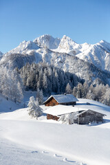 Fototapeta na wymiar Beautiful winter mountain landscape with snowcapped wooden chalet