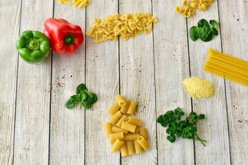 Pasta and fresh organic ingredients for simple Italian recipes to cook at home, photo concept, table top view, copy space