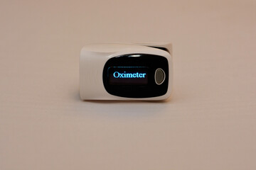 fingertip pulse oximeter medical equipment that measures oxygen saturation in blood and heart rate 