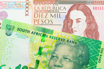 A macro image of a shiny, green 10 rand bill from South Africa paired up with a brown ten thousand bank note from Colombia.  Shot close up in macro.