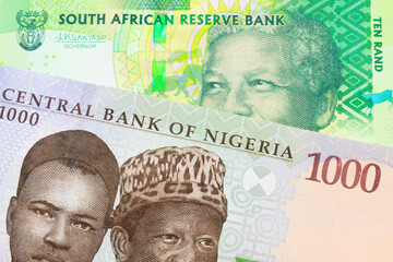 A macro image of a shiny, green 10 rand bill from South Africa paired up with a blue and green one thousand  naira note from Nigeria.  Shot close up in macro.