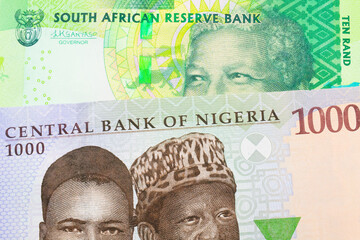 A macro image of a shiny, green 10 rand bill from South Africa paired up with a blue and green one thousand  naira note from Nigeria.  Shot close up in macro.