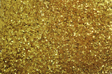 Gold defocused glitter.  Bokeh light of gold glitters background. 