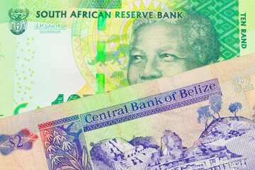 A macro image of a shiny, green 10 rand bill from South Africa paired up with a colorful two dollar bill from Belize.  Shot close up in macro.