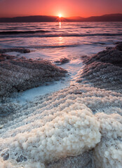 Sunrise over salt crystals in the dead sea, Israel