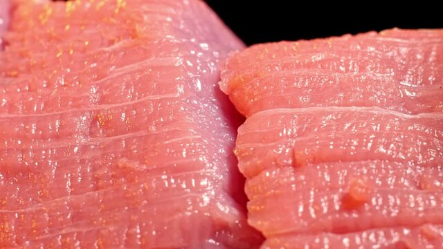 Chef slice a piece of raw beef. Close-up shot of meat slicing. Macro