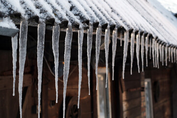 snow and icicles on the roof
