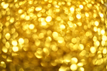 Gold defocused glitter.  Bokeh light of gold glitters background. 