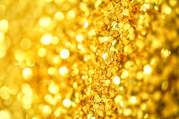 Gold defocused glitter.  Bokeh light of gold glitters background. 