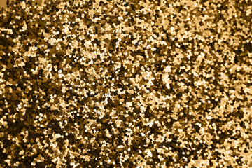 Gold defocused glitter.  Bokeh light of gold glitters background. 