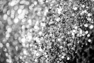 Silver defocused glitter.  Bokeh light of gold glitters background. 