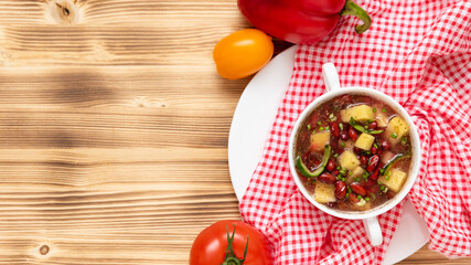 Delicious bean soup with meat on a wooden background. Copy space. Top view.