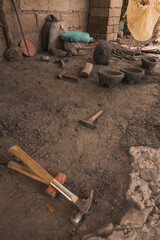 Stone laborer craftsman tools to make molcajetes, traditional Mexican crafts. Hammer, mallet, sincel, and spades. 