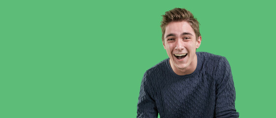 Overjoyed feels the euphoria of an online win, excited happy young guy, the concept of luck on a...