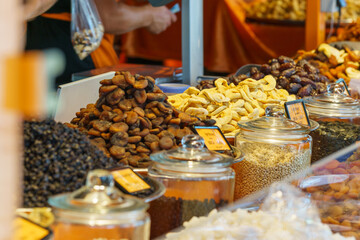 different types of dried fruits and nuts at colorful market stall