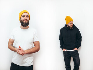 Collage of photos with young handsome bearded hipster guy wearing black blank hoodie and white blank t-shirt . Two guys in empty white tshirt and black hoodie isolated on white background