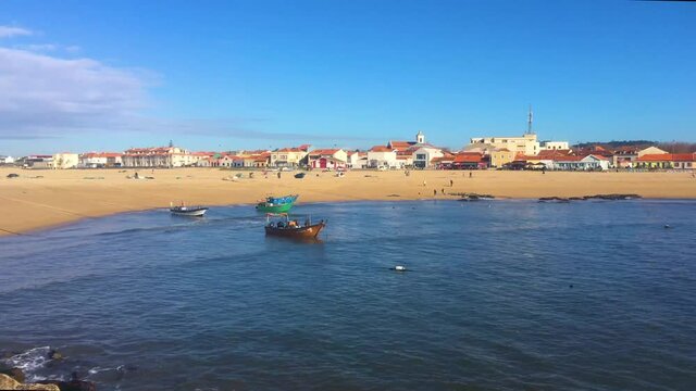 View of the beach, traditional fishing boat and restaurants at Aguda beach. Vila Nova de Gaia, Porto, Portugal,