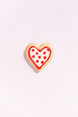 close up of a homemade heart shaped valentines sugar cookie with colorful icing