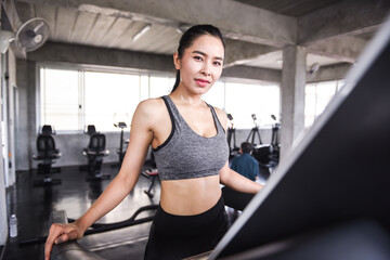 Fototapeta na wymiar Asian young woman exercising in the gym Enhance health For strength Exercise concept