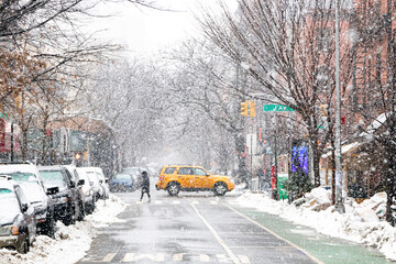 Snowy winter street scene at an intersection on 1st Avenue in the East Village of New York City