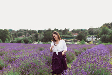 The young joyful woman is running in the Lavender field