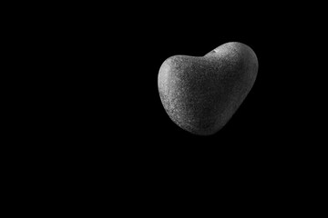 A heart-shaped stone in the air, black background, black and white, heart shaped, rock heart, love is in the air, pebble heart, valentines day, 14th February, 
