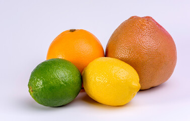 A citrus shot of a grapefruit, lemon, lime and orange on white