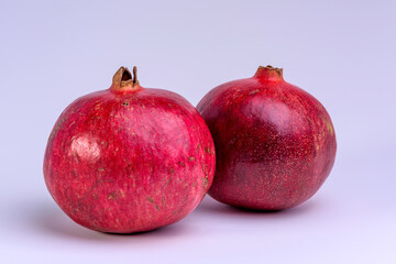 Two pomegranates on a white background