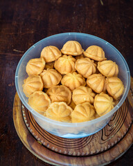 Kuih Bahulu, baulu or bolu in a container. Sponge cake baked in special aluminium moulds is the Asian tradition food in popular Malaysia and Indonesia.
