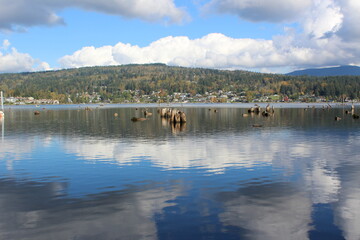 Fototapeta premium Reflection of the sky and clouds on the calm water of Lake Whatcom in fall