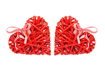Pair of decorative red wicker hearts with ribbons isolated on white background. The concept of true and mutual love.