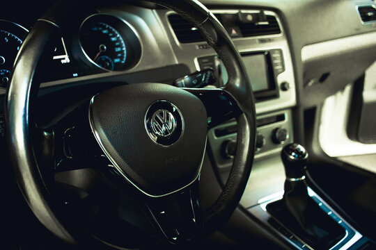 Volkswagen. Carro, Veículo, Indústria automotiva. Foto Interior de um carro Golf da marca Volkswagen com foco na logo no volante.