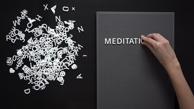 Thin Female Hand Lays Out Words MEDITATION On A Dark Grey Board Mental Health Concept Take Care Of Yourself Copy Space 