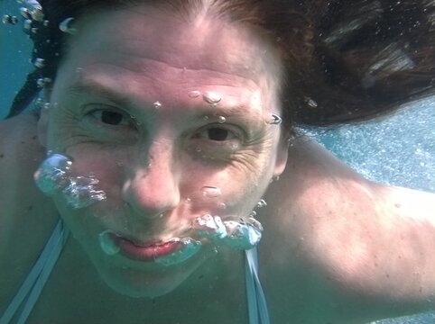 Close-up Portrait Of Mature Woman Swimming In Pool