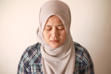 Sad depressed anxiety Asian muslim woman thinking contemplating bad thing happened in her life, stress exhausted feeling down expression, financial or relationship problem