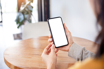 cell phone blank white screen mockup.woman hand holding texting using mobile on desk at office.background empty space for advertise.work people contact marketing business,technology