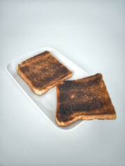 2 slices of burnt toasts. Selective focus points