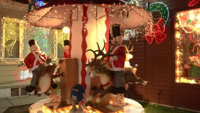 View of Guards Riding a Reindeer Merry Go Round at a Christmas House