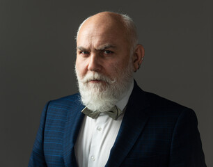 Serious Senior Man. Bearded middle-aged man with a serious expression in a closeup head and shoulders portrait.