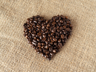 love shape coffee beans on linen texture background