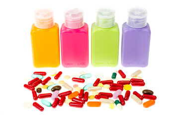 Multi-colored plastic bottles, containers with pills and capsules isolated on white background.