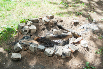 A bunch of ashes after the fire. Charcoal in the forest, stones